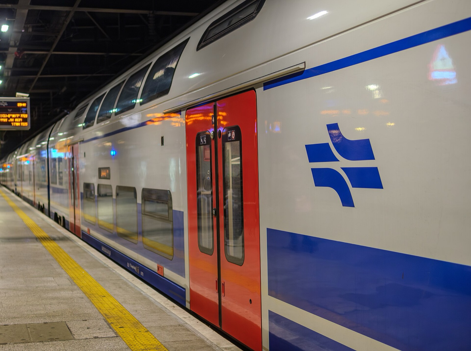 An Israel Railways double-deck train waiting at a Tel Aviv platform