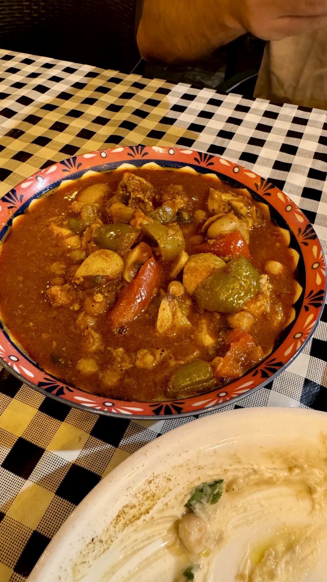 A bowl of brain soup at HaTeimani, with peppers, tomatoes and chickpeas
